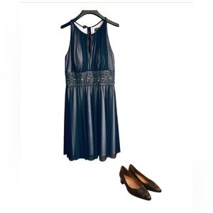 Sleeveless formal dress, sheer navy over lavender with sequencing and gem waist.
